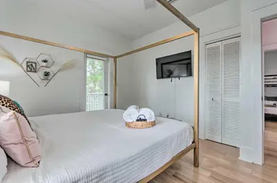 a bedroom with a bed with a basket of towels on it at Easy Walk to Seagrove Beach Beverly Bungalow in Santa Rosa Beach