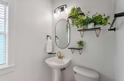 a bathroom with a sink and a mirror and plants at Easy Walk to Seagrove Beach Beverly Bungalow in Santa Rosa Beach