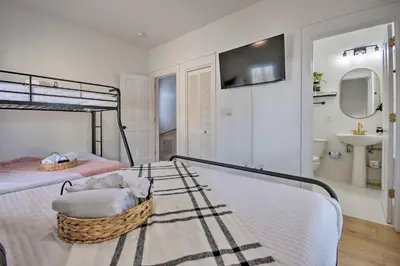 a bedroom with a bunk bed and a bathroom with a sink at Easy Walk to Seagrove Beach Beverly Bungalow in Santa Rosa Beach