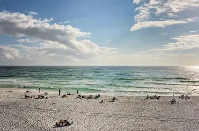 a group of people on a beach near the ocean at Easy Walk to Seagrove Beach Beverly Bungalow in Santa Rosa Beach