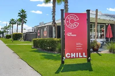 a red sign in the grass next to a sidewalk at Prominence on 30A Rentals by Panhandle Getaways in Watersound Beach