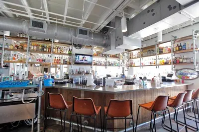 a bar with orange chairs in a restaurant at Prominence on 30A Rentals by Panhandle Getaways in Watersound Beach