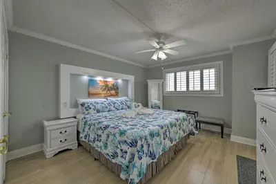 a bedroom with a bed and a ceiling fan at PCB Condo with Community Perks and Beach Access in Panama City Beach