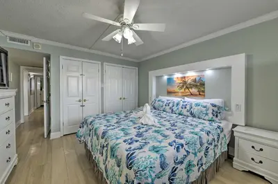 a bedroom with a bed and a ceiling fan at PCB Condo with Community Perks and Beach Access in Panama City Beach