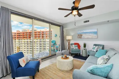 a living room with a couch and chairs and a large window at Shores of Panama 2024 in Panama City Beach
