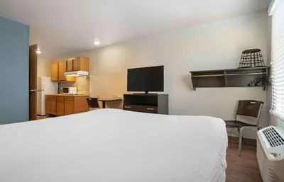 a hotel room with a bed and a television at Extended Stay America Select Suites - Panama City - Callaway in Callaway