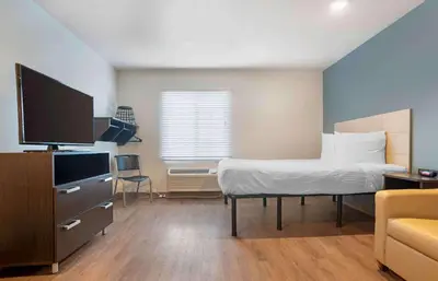 a bedroom with a bed and a tv and a couch at Extended Stay America Select Suites - Panama City - Callaway in Callaway