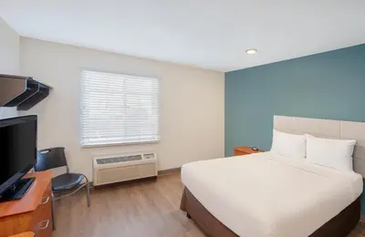 a hotel room with a bed and a television at Extended Stay America Select Suites - Panama City - Callaway in Callaway