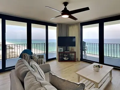 a living room with a couch and a tv at Watercrest 1401 in Panama City Beach