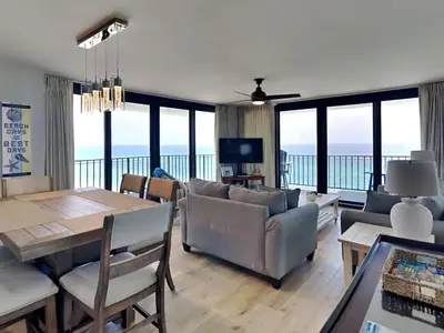 a living room with a couch and a table and chairs at Watercrest 1401 in Panama City Beach