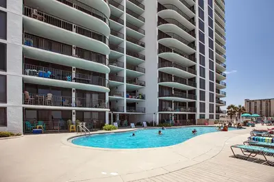 a swimming pool in front of a large apartment building at Watercrest 1401 in Panama City Beach