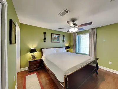 a bedroom with a bed and a ceiling fan at Tidewater Beach Resort #2607 in Panama City Beach