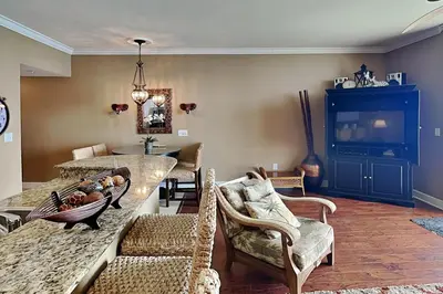 a living room with a couch and a table and chairs at Tidewater Beach Resort #2607 in Panama City Beach