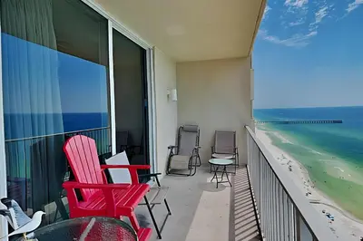 a balcony with chairs and a view of the beach at Tidewater Beach Resort #2607 in Panama City Beach