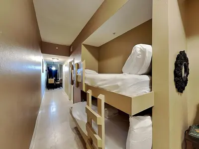 a room with two bunk beds and a hallway at Tidewater Beach Resort #2607 in Panama City Beach