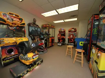 a room with many arcade games and other games at Tidewater Beach Resort #2607 in Panama City Beach