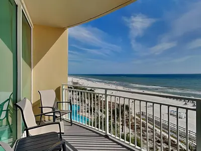 a balcony with chairs and a view of the beach at Aqua 404 in Panama City Beach