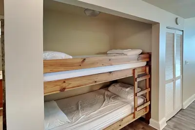 a room with two bunk beds in it at Aqua 404 in Panama City Beach