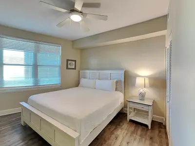 a bedroom with a bed and a ceiling fan at Aqua 404 in Panama City Beach