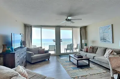a living room with a couch and a table at Aqua 404 in Panama City Beach