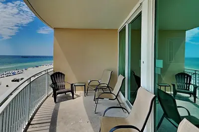 a balcony with chairs and a view of the beach at Aqua 404 in Panama City Beach