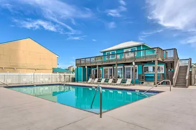 a house with a swimming pool in front of a house at Walk to Beach PCB Condo with Oceanfront Pool Access in Panama City Beach
