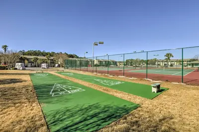 a tennis court with a green tennis court at Walk to Beach PCB Condo with Oceanfront Pool Access in Panama City Beach