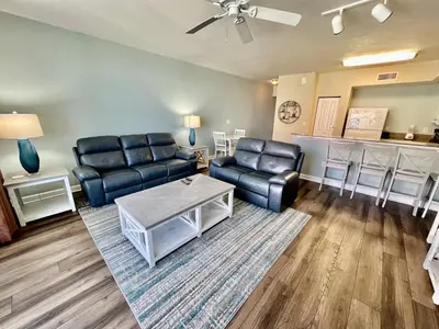 a living room with a couch and a table at Shores of Panama Resort, Direct Beachfront, 1 BR plus Bunks! by Dolce Vita Getaways PCB in Panama City Beach