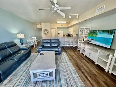 a living room with a couch and a flat screen tv at Shores of Panama Resort, Direct Beachfront, 1 BR plus Bunks! by Dolce Vita Getaways PCB in Panama City Beach