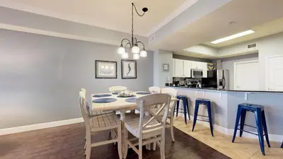 a kitchen and dining room with a table and chairs at Tidewater 2608 in Panama City Beach