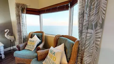 a room with two chairs and a large window at Tidewater 2608 in Panama City Beach