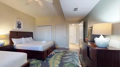 a bedroom with a bed and a television in it at Tidewater 2608 in Panama City Beach