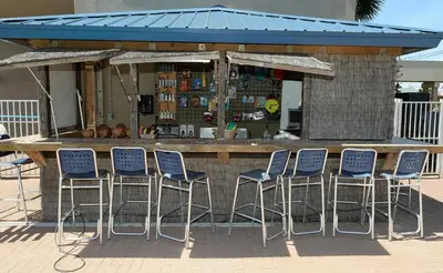 a bar with blue chairs in front of a kiosk at Tidewater 2608 in Panama City Beach