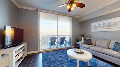 a living room with a couch and a tv at Tidewater 2608 in Panama City Beach