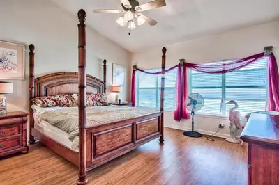 a bedroom with a canopy bed and a fan at Beachside #8 - Beachfront - Sleeps 10! in Panama City Beach
