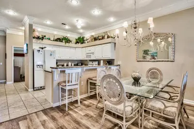 a kitchen and dining room with a table and chairs at Beachside #8 - Beachfront - Sleeps 10! in Panama City Beach