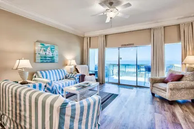 a living room with two couches and a view of the ocean at Beachside #8 - Beachfront - Sleeps 10! in Panama City Beach