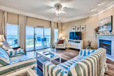 a living room with a couch and a fireplace at Beachside #8 - Beachfront - Sleeps 10! in Panama City Beach