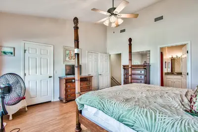 a bedroom with a bed and a ceiling fan at Beachside #8 - Beachfront - Sleeps 10! in Panama City Beach