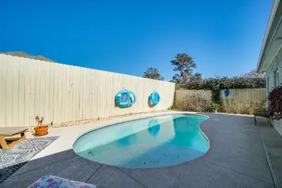 a swimming pool in a backyard with a fence at Panama City Beach House - The Starfish by Panhandle Getaways in Panama City Beach