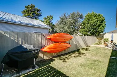 two orange kayaks are hanging on a fence at Panama City Beach House - The Starfish by Panhandle Getaways in Panama City Beach