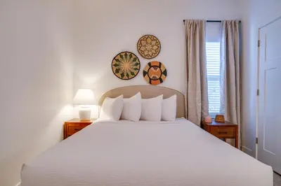 a bedroom with a white bed and a window at Panama City Beach House - The Starfish by Panhandle Getaways in Panama City Beach