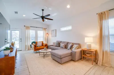 a living room with a couch and a ceiling fan at Panama City Beach House - The Starfish by Panhandle Getaways in Panama City Beach
