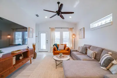 a living room with a couch and a ceiling fan at Panama City Beach House - The Starfish by Panhandle Getaways in Panama City Beach