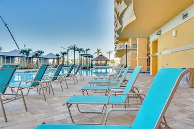 a row of chairs sitting next to a swimming pool at Calypso Resort Tower 3 by Panhandle Getaways in Panama City Beach