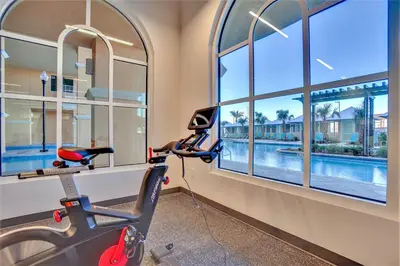 a room with windows and a moped and a swimming pool at Calypso Resort Tower 3 by Panhandle Getaways in Panama City Beach