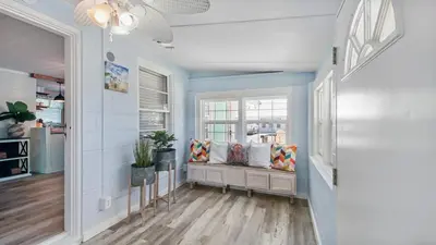 a hallway with a bench with pillows on it at Delmar Dunes by Sand Seeker Vacations in Panama City Beach