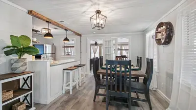 a dining room and kitchen with a table and chairs at Delmar Dunes by Sand Seeker Vacations in Panama City Beach