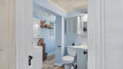 a bathroom with a toilet and a sink at Delmar Dunes by Sand Seeker Vacations in Panama City Beach