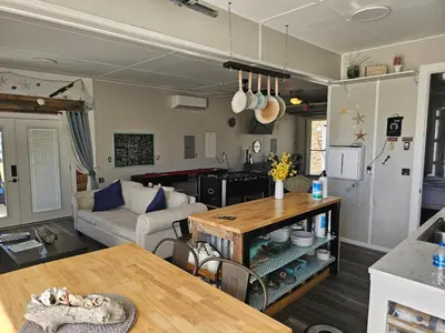 a living room with a couch and a table at Hidden Gem Guest House in Panama City Beach